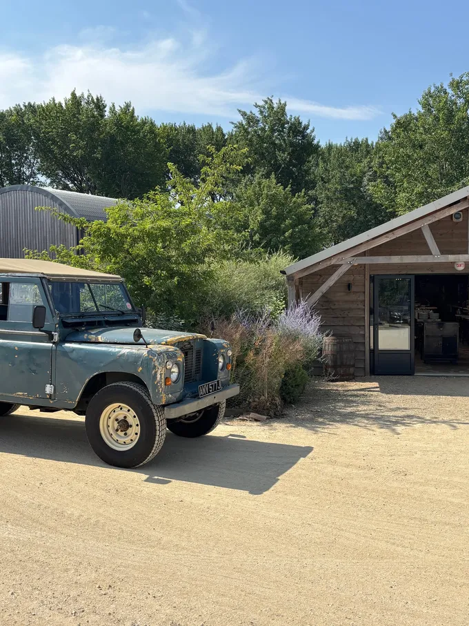 The Series 2a on the gravel outside a timber barn