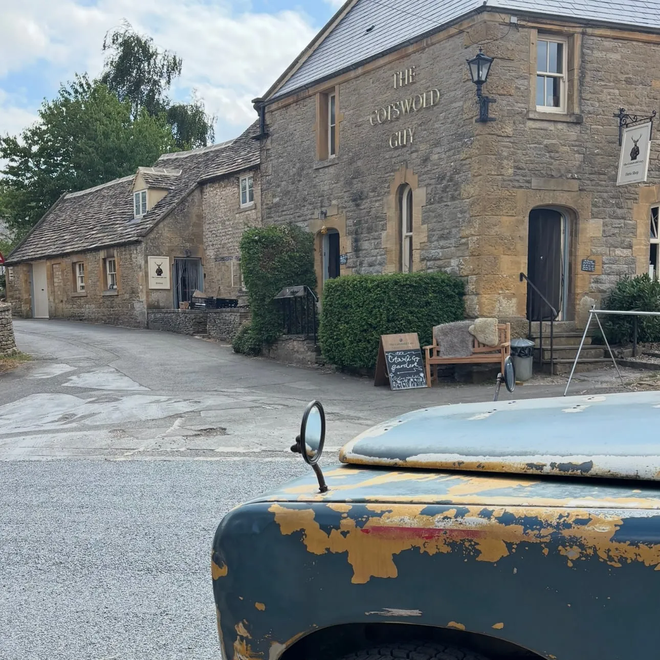 The Cotswold Guy farm shop in Guiting Power, with the Land Rover parked across the lane
